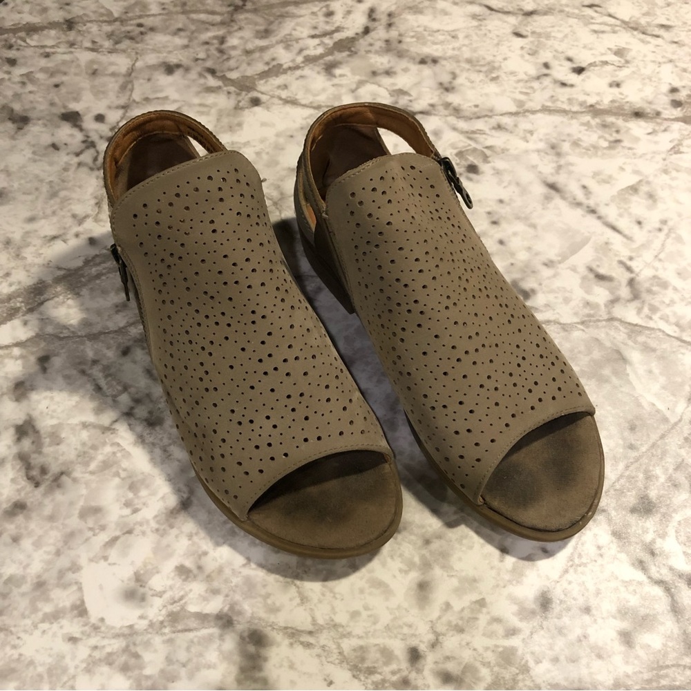Baretraps open toe flat sandal with a perforated top and a side zipper